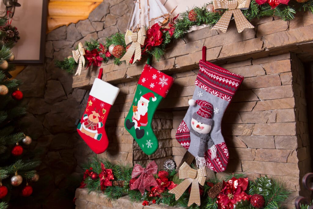 stone fireplace decorated with christmas stockings
