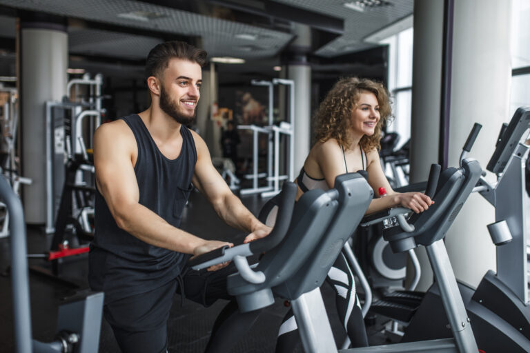 attractive young woman her trainer running treadmill gym